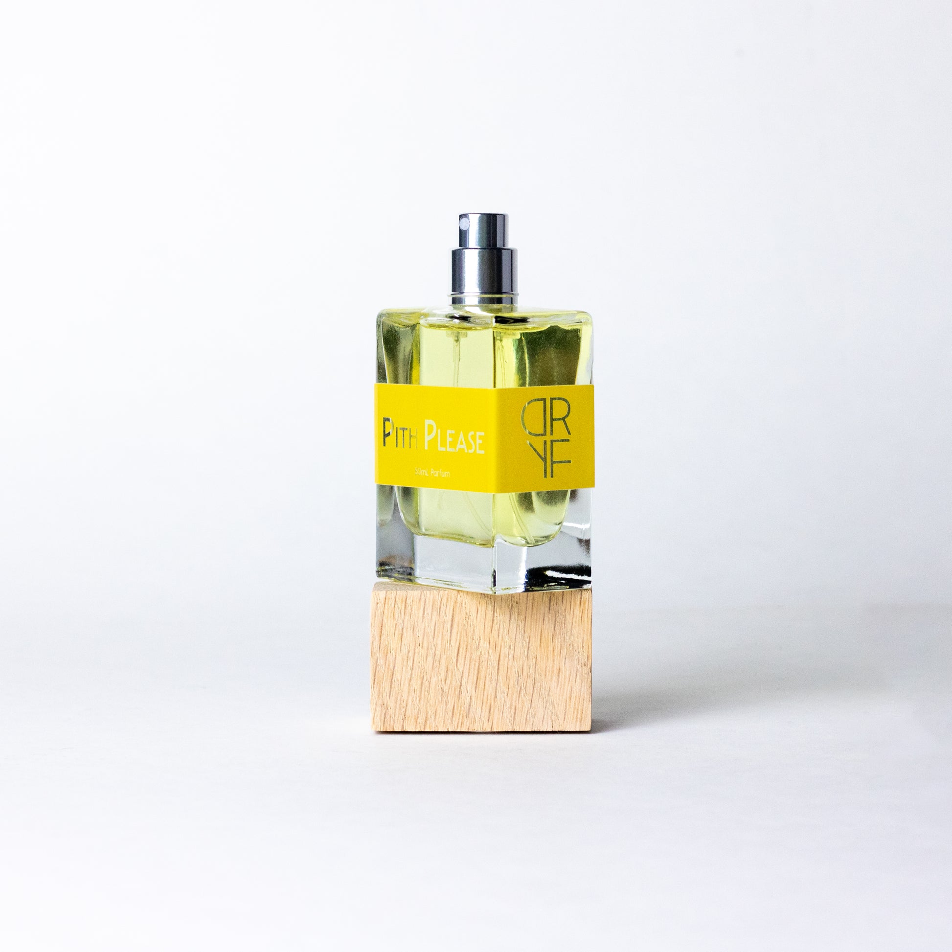 Handcrafted unisex fragrance Pith Please, with lively citrus, creamy woods, and sweet vanilla, inspired by sunlit mornings and joyful moments.