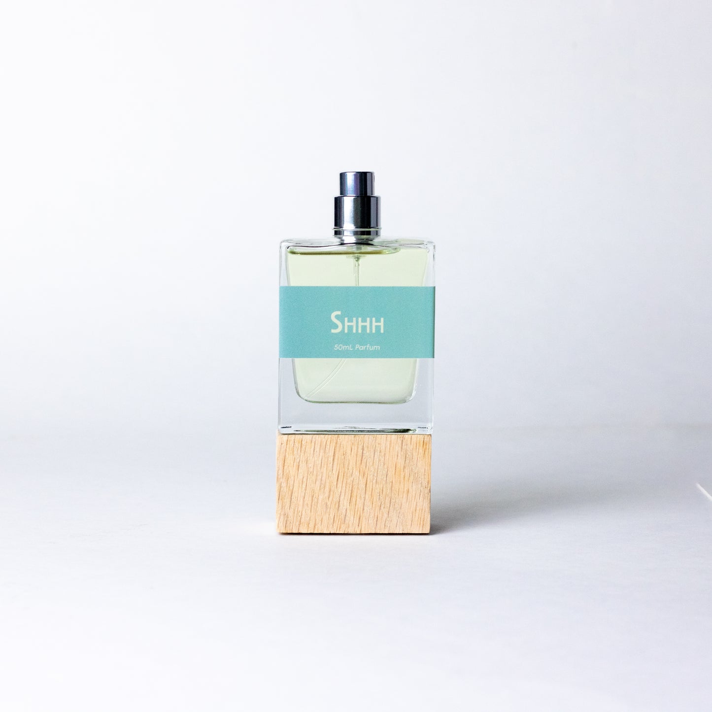 Shhh by DRYF, a soothing fragrance with notes of fresh sea salt, creamy coconut, and resinous amber, perfect for quiet reflection.