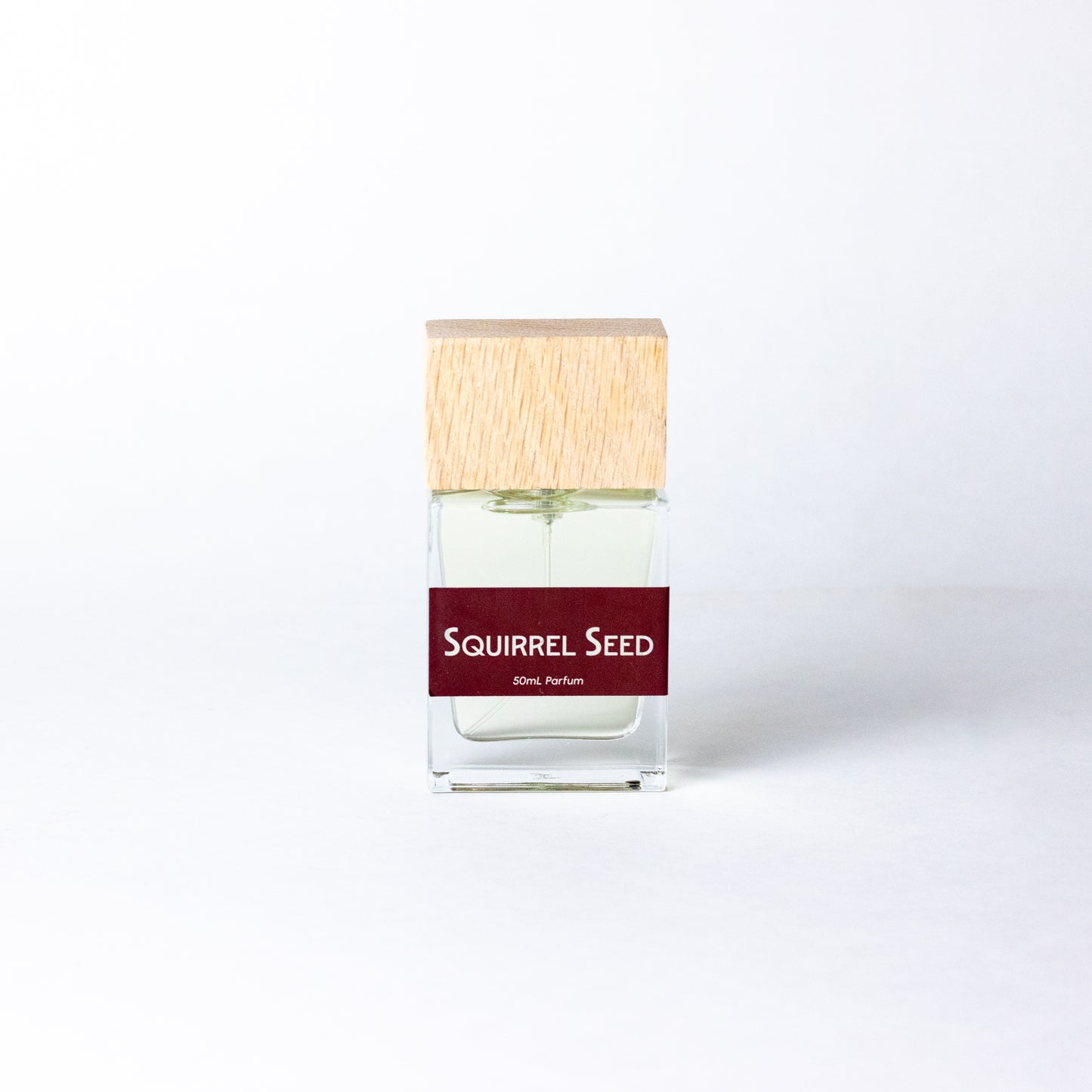 Squirrel Seed by DRYF, an artisanal fragrance combining juicy citrus and pomegranate with rich resins and musks for a mysterious, woodsy aroma.
