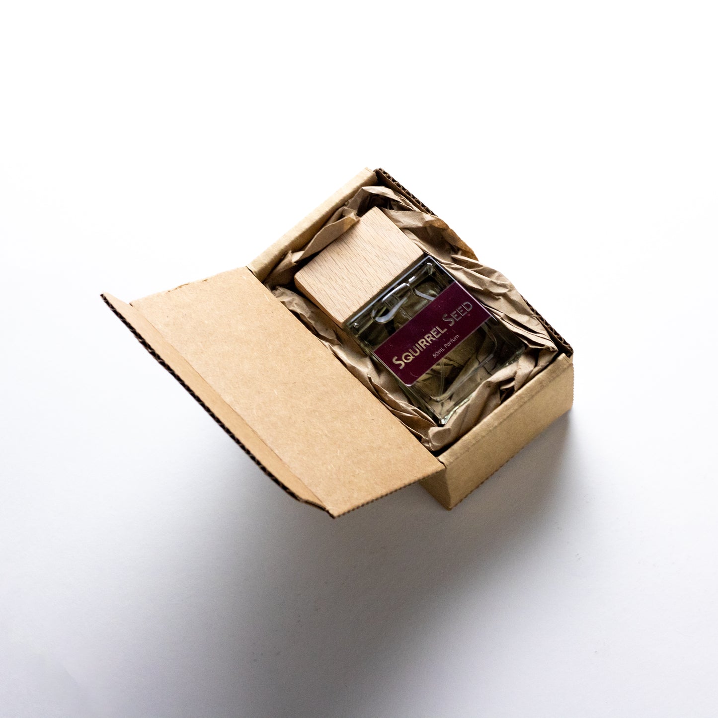 DRYF's Squirrel Seed fragrance, a captivating unisex blend of ginger, lime, pomegranate, and earthy woods, celebrating the mystery of nature all packaged in an eco-friendly box.
